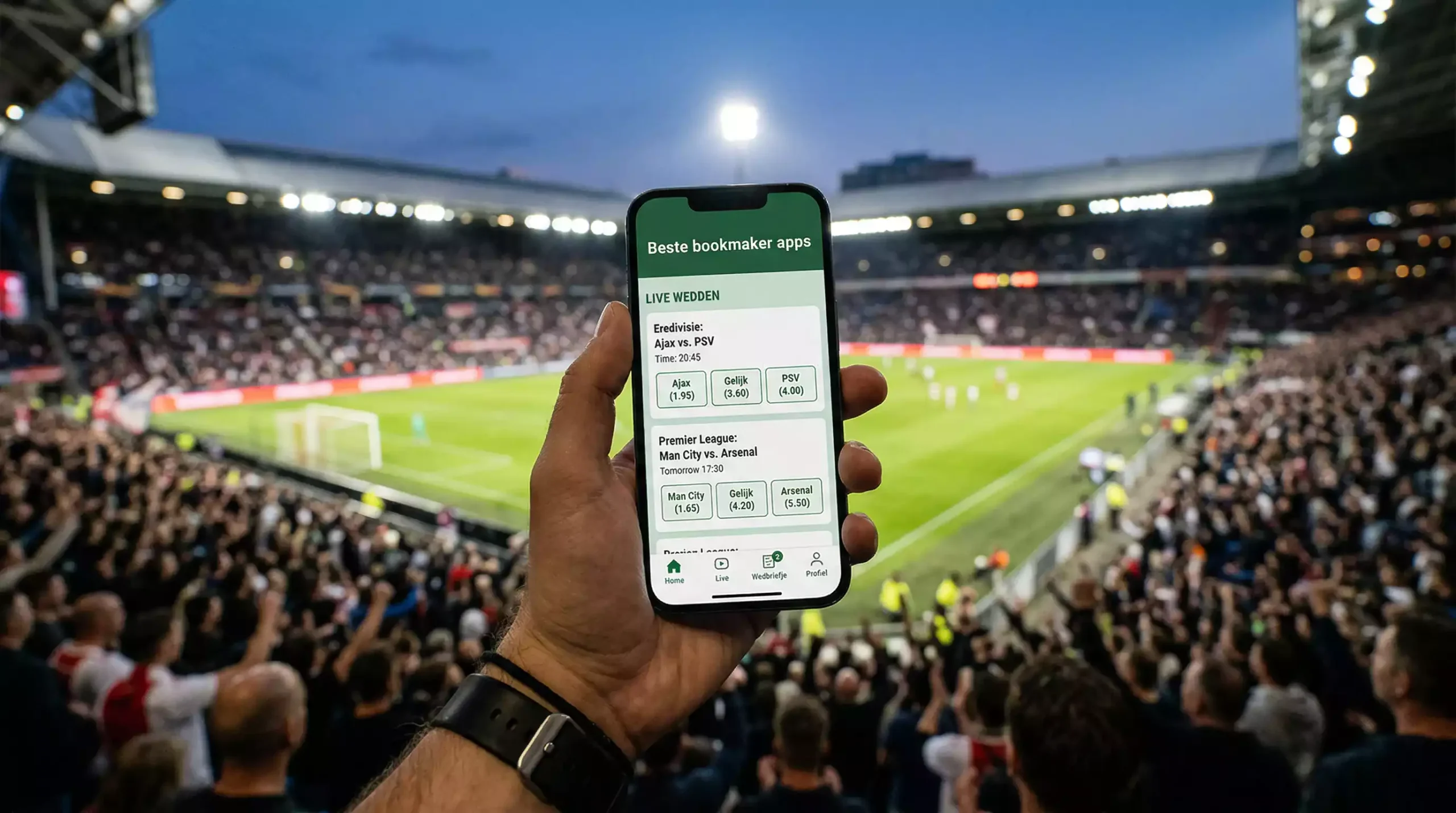 Hand houdt smartphone vast met sportwedden app in een stadion